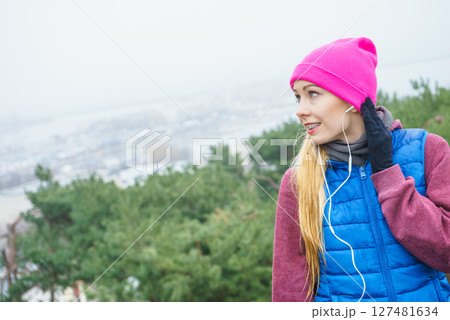 Woman wearing sportswear exercising outside during autumn Woman wearing sportswear exercising outside during autumn 127481634