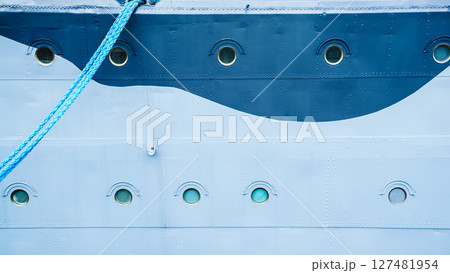 Closeup of ship with hanging mooring rope 127481954