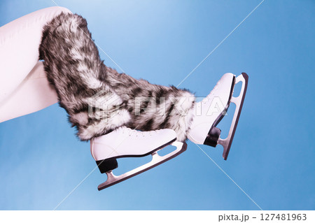 Woman legs wearing ice skates fur socks, skating 127481963