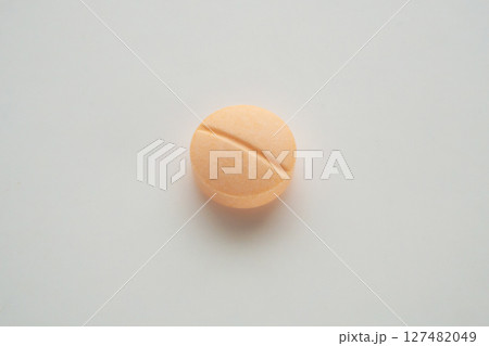 Orange medicine pill tablet on white background Orange medicine pill tablet on white background 127482049