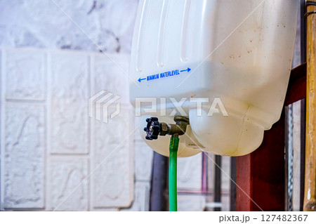 Plastic tank with minimum water level text and pipe Plastic tank with minimum water level text and pipe 127482367