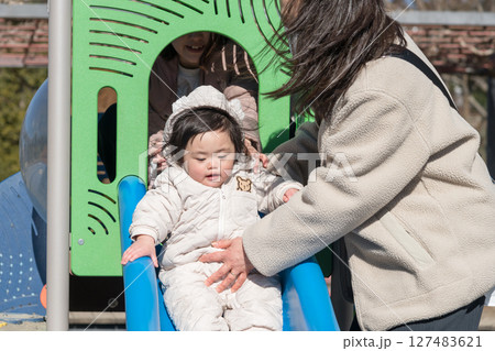 【相模原市立麻溝公園の子どもの広場でママとババで遊ぶ1歳児】 127483621