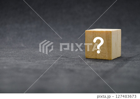 Single wooden cube with question mark on front, isolated on light background Single wooden cube with question mark on front, isolated on light background 127483673