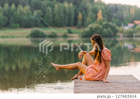 Woman Splashing Water On Lake Pier 127483914
