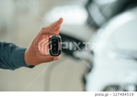 Close up view of man that is with electrical car Close up view of man that is with electrical car 127484519