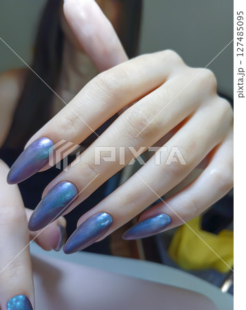 Nail extensions, manicure, nail correction, hands in the foreground gel polishes 127485095