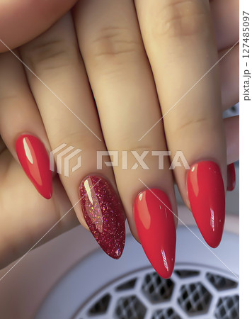 Nail extensions, manicure, nail correction, hands in the foreground gel polishes 127485097