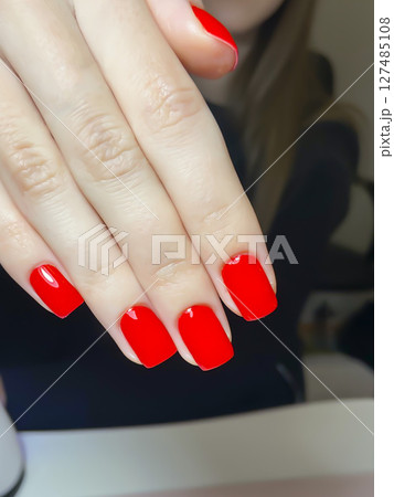 Nail extensions, manicure, nail correction, hands in the foreground gel polishes Nail extensions, manicure, nail correction, hands in the foreground gel polishes 127485108