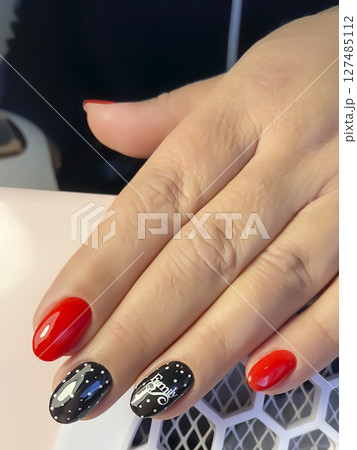 Nail extensions, manicure, nail correction, hands in the foreground gel polishes Nail extensions, manicure, nail correction, hands in the foreground gel polishes 127485112