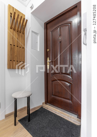 Closed Wooden Apartment Door in Bright Hallway 127485208