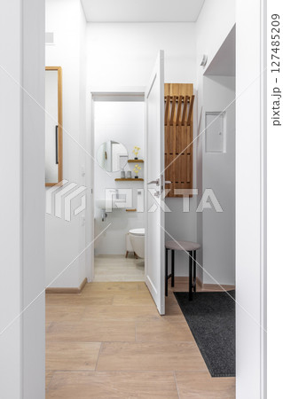 Bright Hallway Leading to Modern Bathroom 127485209
