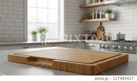 Empty wooden cutting board with a juice groove on a kitchen counter in a modern home Empty wooden cutting board with a juice groove on a kitchen counter in a modern home 127485427