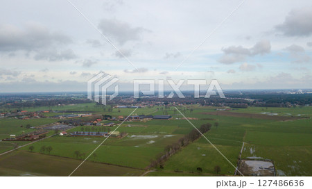 An aerial view of tranquil countryside with vast green fields and charming villages 127486636