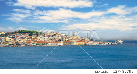 Wide panoramic shot of Lisbon, its beautiful city center, historic buildings, iconic landmarks and Tagus River under blue sky with some white clouds on sunny day. Colorful skyline with castle on hill Wide panoramic shot of Lisbon, its beautiful city center, historic buildings, iconic landmarks and Tagus River under blue sky with some white clouds on sunny day. Colorful skyline with castle on hill 127486796