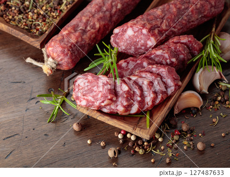Sliced smoked sausage with herbs and spices. Sliced smoked sausage with herbs and spices. 127487633