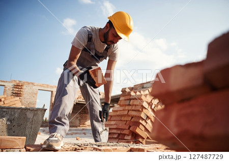 Outdoors at daytime. Handsome Indian man is on the construction site 127487729