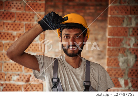Portrait of handsome Indian man that is on the construction site 127487755