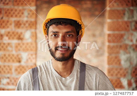 Portrait of handsome Indian man that is on the construction site 127487757