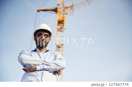 Manager in sunglasses. Handsome Indian man is on the construction site 127487774
