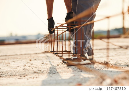 Close up view of man that is working on the construction site Close up view of man that is working on the construction site 127487810