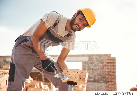 Outdoors at daytime. Handsome Indian man is on the construction site 127487862