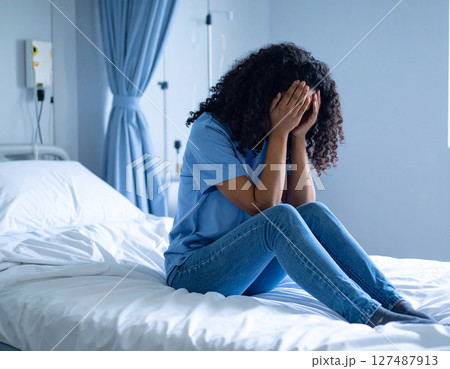 ベッドで頭を抱える女性 127487913
