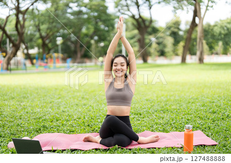Yoga practice outdoors. Young woman performing yoga poses in a park. 127488888