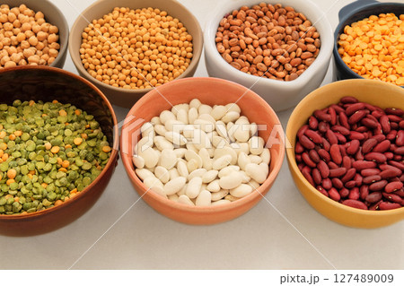 Variety of protein products for vegetarians. Soy, lentils, peas, chickpeas and various types of beans in bowls. Top view. Place for text. Variety of protein products for vegetarians. Soy, lentils, peas, chickpeas and various types of beans in bowls. Top view. Place for text. 127489009