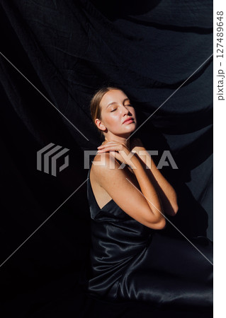 Beautiful fashion woman in black summer silk dress 127489648