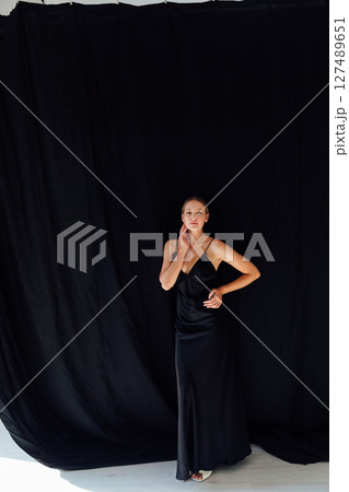 Beautiful fashion woman in black summer silk dress 127489651