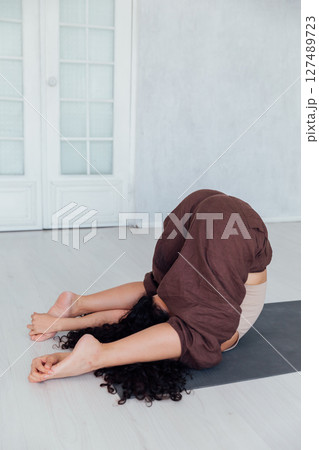 Fitness Woman Brunette Doing Gymnastics Yoga Asana On The Floor Fitness Woman Brunette Doing Gymnastics Yoga Asana On The Floor 127489723