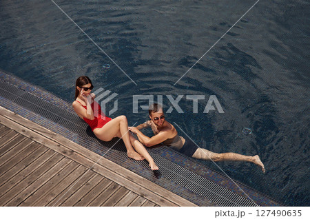 Vacation time, top view. Man with woman is in the pool together 127490635