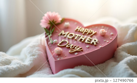 Heart-shaped Mother's Day cake decorated with pink flower and lettering Heart-shaped Mother's Day cake decorated with pink flower and lettering 127490766