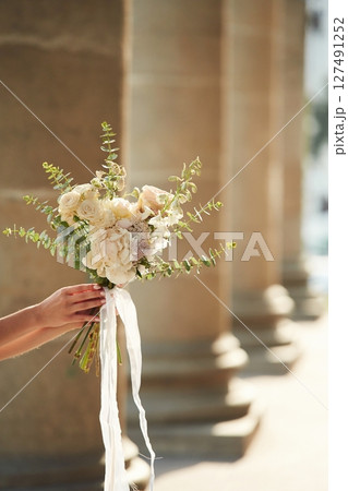 Close up view of woman that is with flowers in hands 127491252