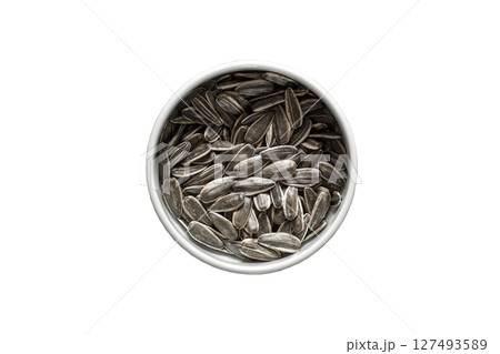 Sunflower seeds, unpeeled striped in white bowl, isolated on white background with clipping path  127493589