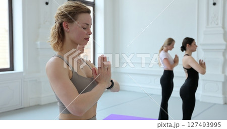 Young women practicing yoga in a spacious yoga room. Concept of healthy lifestyles and self development. Young women practicing yoga in a spacious yoga room. Concept of healthy lifestyles and self development. 127493995
