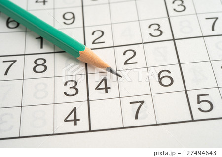 Sudoku puzzle game playing to challenge brain. Sudoku puzzle game playing to challenge brain. 127494643