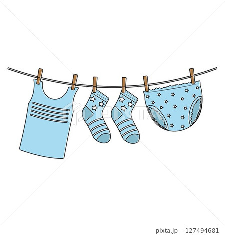Drying wet children's clothes hung on a clothesline 127494681