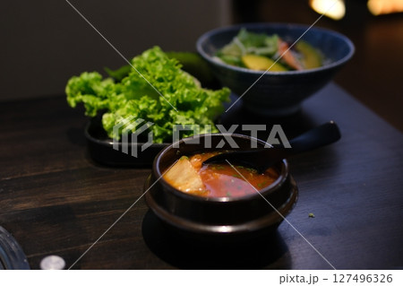 tomato soup in a black plate Bowl of tomato soup in black bowl isolated on white background 127496326