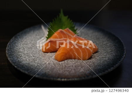 Salmon sashimi with Wasabi on pottery dish 127496340