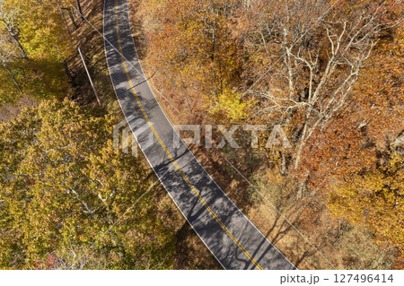Road trip travel in Appalachian mountains. Car driving on parkway through woods nature in fall season. Colorful forest in autumn Tennessee Road trip travel in Appalachian mountains. Car driving on parkway through woods nature in fall season. Colorful forest in autumn Tennessee 127496414