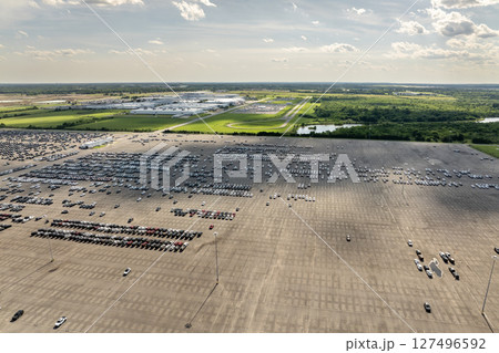 New cars stock at production factory parking lot. Vehicles parked in a row at dealer port terminal. Automotive industry. Import or export of new cars at warehouse 127496592