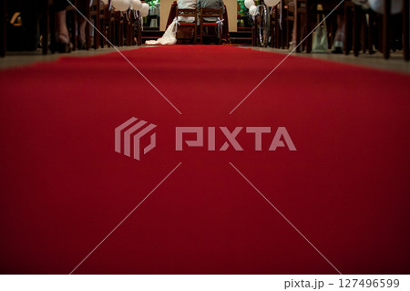 An Elegant and Beautiful Wedding Ceremony featuring a vivid Red Aisle Runner for the event 127496599