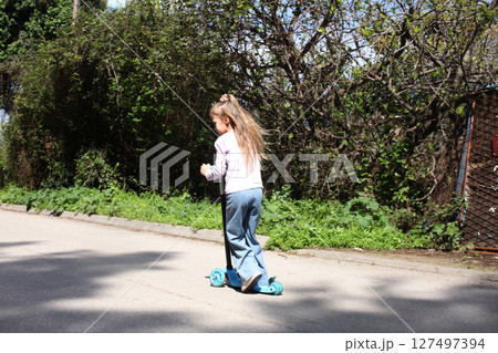 little cute girl riding a bicycle in green park, lifestyle people concept 127497394