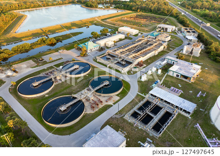 Large-scale industrial water treatment plant purifying and recycling water through filtration and chemical processes to meet health and safety standards Large-scale industrial water treatment plant purifying and recycling water through filtration and chemical processes to meet health and safety standards 127497645