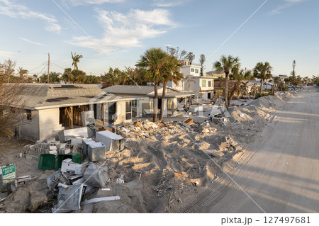 Hurricane Milton on Manasota Key in Englewood, Florida. Piles of rubbish on street side from severely damaged houses. Consequences of natural disaster Hurricane Milton on Manasota Key in Englewood, Florida. Piles of rubbish on street side from severely damaged houses. Consequences of natural disaster 127497681
