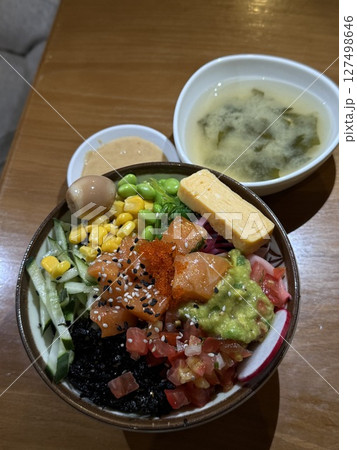 vertical photo Poke bowl soup Wok rice with vegetables. Composition on black background. The Art of Japanese Cuisine. Food photography for menu and sushi bar decoration vertical photo Poke bowl soup Wok rice with vegetables. Composition on black background. The Art of Japanese Cuisine. Food photography for menu and sushi bar decoration 127498646