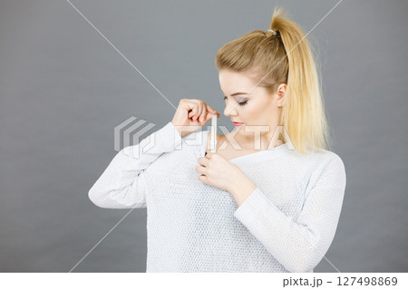 Woman holding her bra strap Woman holding her bra strap 127498869