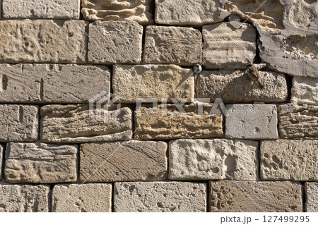 Rustic brick wall featuring weathered textures, with two small birds Rustic brick wall featuring weathered textures, with two small birds 127499295