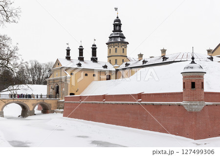 Historic castle with brick walls and snow-covered surroundings 127499306